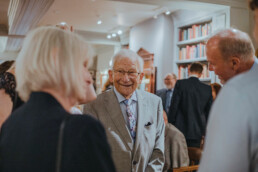 smiling Elderly man socializing at event